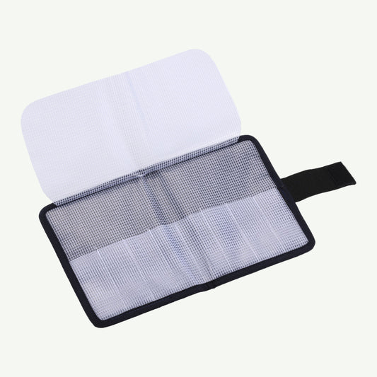 Screen cleaning kit with a white cloth and mesh pad on a white background