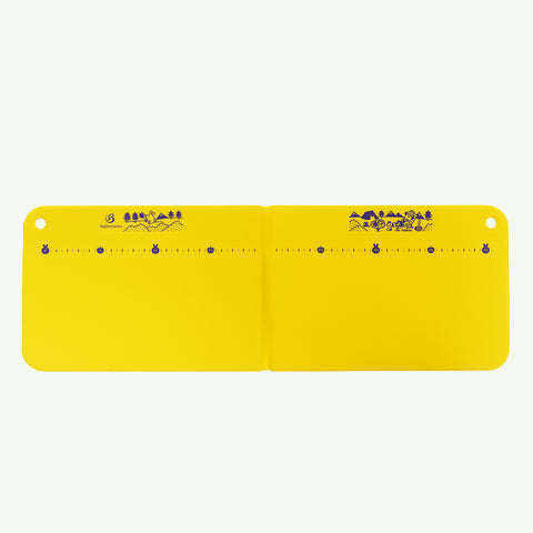 Yellow ruler with measurement markings on a white background